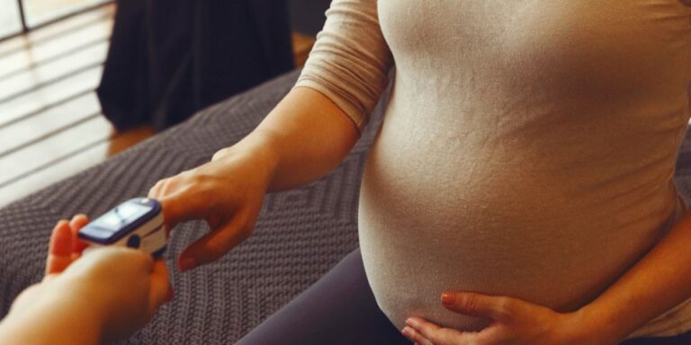 pregnant woman at doctor office questions to ask in third trimester appointment